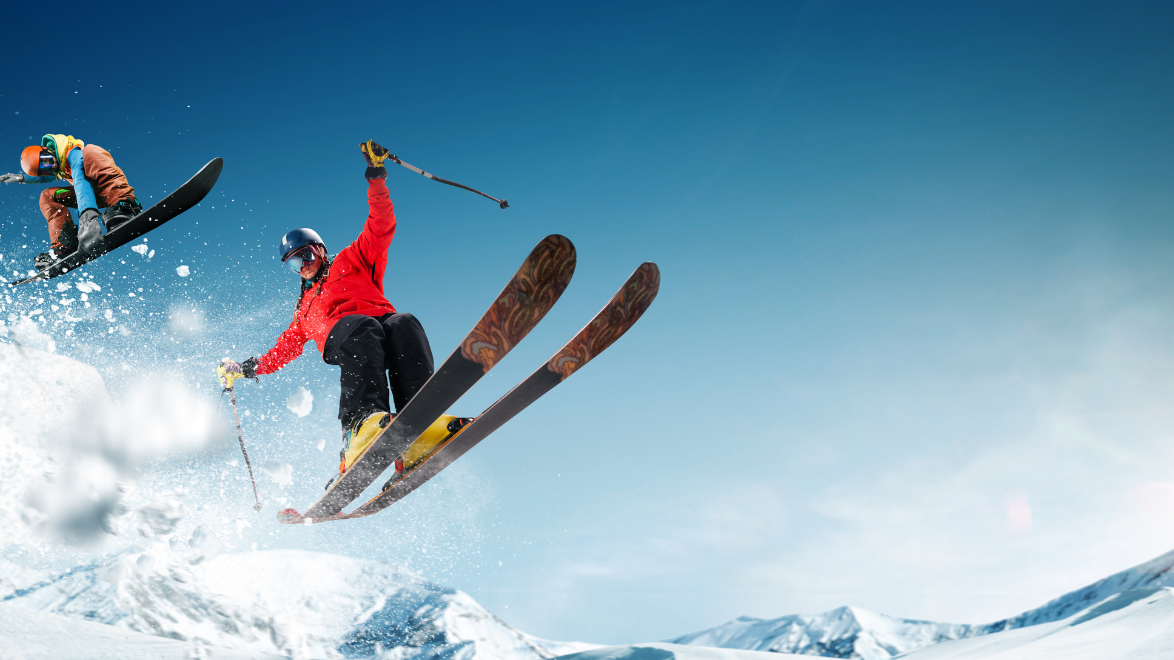 Skier and Snowboarder going off a jump