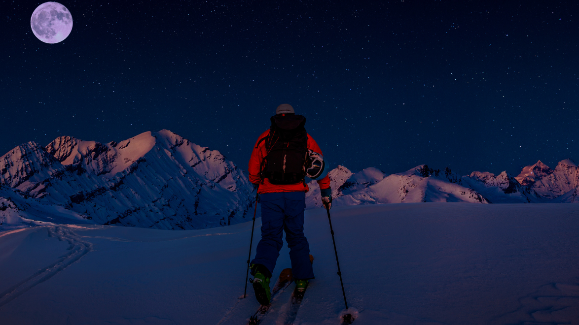 Man backcountry skiing in the dark